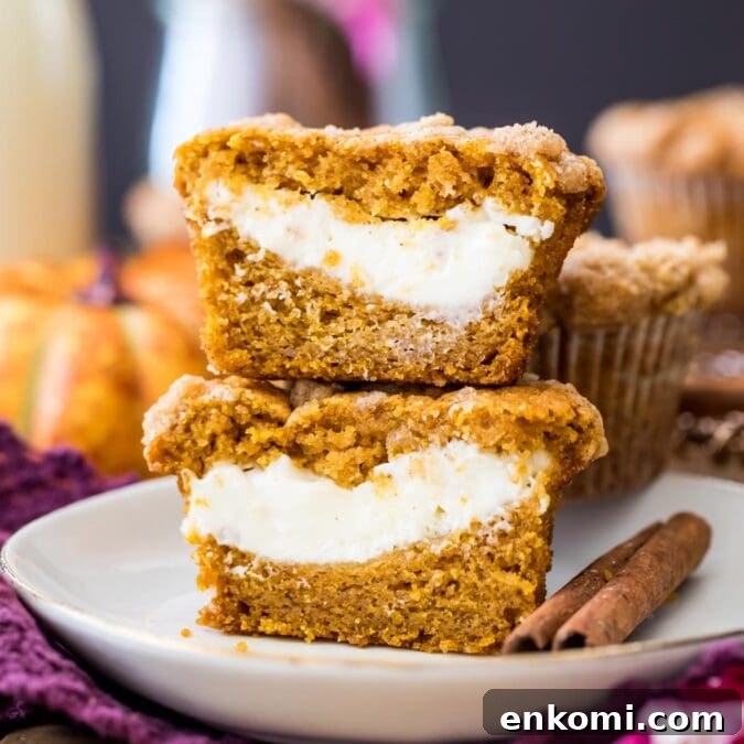 30 Muffin Recipes: Sweet, Savory & Seasonal Ideas 26 two halves of a pumpkin cream cheese muffin stacked on top of each other to show their cheesecake centers