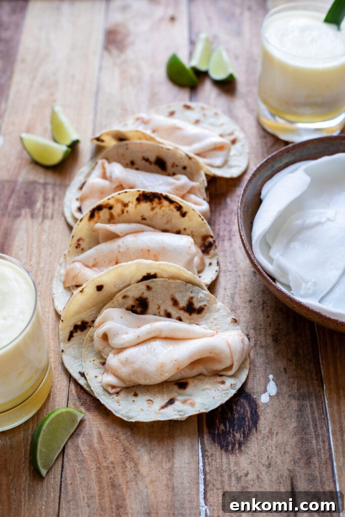 Chili-Lime Coconut Street Tacos with Spiced Meat 4 coconut meat dipped in chili lime sauce in a taco