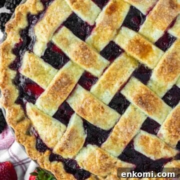 Strawberry blackberry pie on kitchen towel.