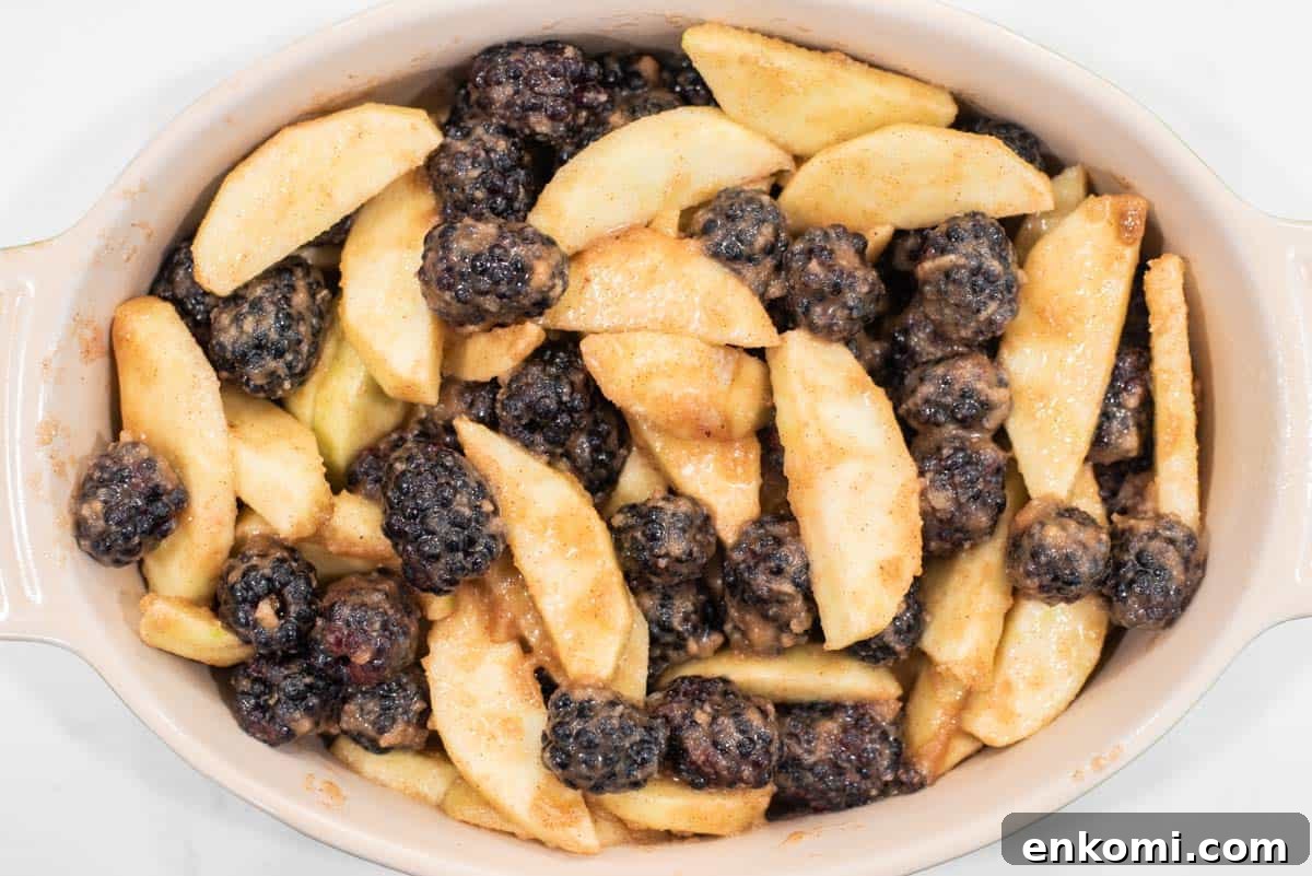 Apple and Blackberry Crumble Recipe for Summer Desserts 7 Apple and blackberry filling spread in baking dish.